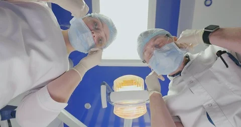 Concept of teethcare. Two dentists in white uniform take off masks after teeth Stock Footage 108540173
