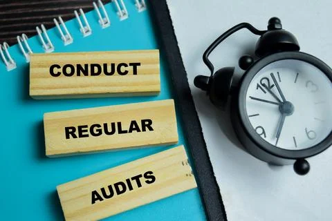 Concept of text conduct regular audits on wooden blocks. For finance Stock Photos