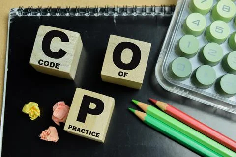 Concept of text COP - Code Of Practice on wooden blocks. 库存照片