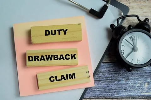 Concept of text duty drawback claim on wooden blocks. For international trade Stock Photos