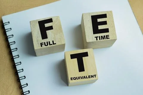 Concept of text FTE - Full Time Equivalent on wooden blocks. Stock Photos