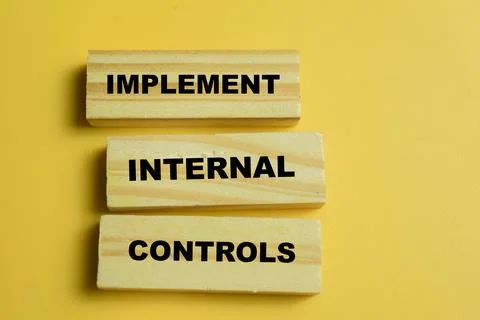 Concept of text implement internal controls on wooden blocks. Stock Photos