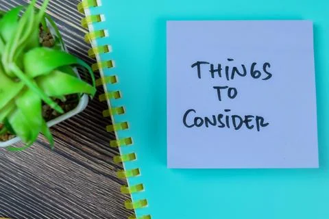 Concept of Things to Consider write on sticky notes isolated on Wooden Table. Stock Photos