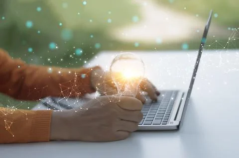 The concept of thinking and creativity, the light bulb in the hand, the dev.. Stock Photos