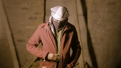Concept of threat from suicide bomber attack, gangster with face cover taking Stock Footage 168818090