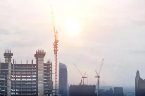 The concept of a tower crane in construction is to build a big city. Stock Photos