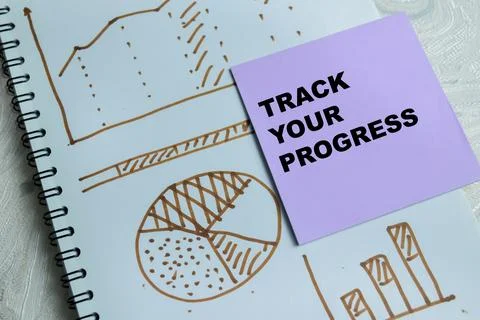 Concept of track your progress write on sticky notes isolated on Wooden Table 스톡 사진