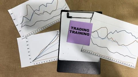 Concept of Trading Training write on sticky notes isolated on Wooden Table. Stock Photos
