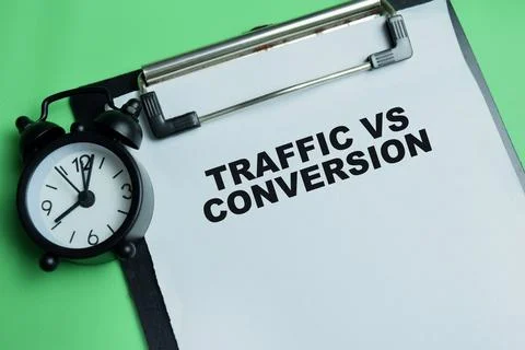 Concept of traffic vs conversion write on clipboard isolated on table. Stock Photos