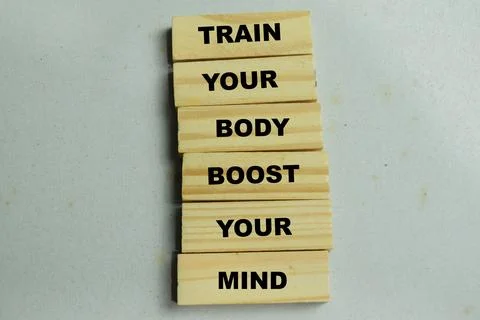 Concept of train your body boost your mind text on wooden blocks. Stock Photos