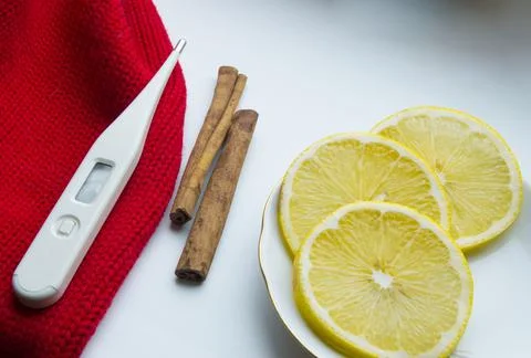 The concept of treating colds - lemon, cinnamon, thermometer, scarf Stock Photos