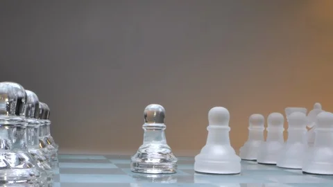 Concept two pawns standing opposite, two powers, glass chess Stock Footage 126961801