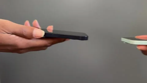 Concept of two people airdropping to each other Stock Footage 308218491