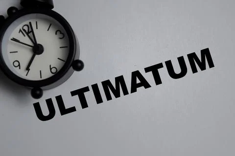 Concept of ultimatum write on book isolated on Wooden Table Fotos de archivo
