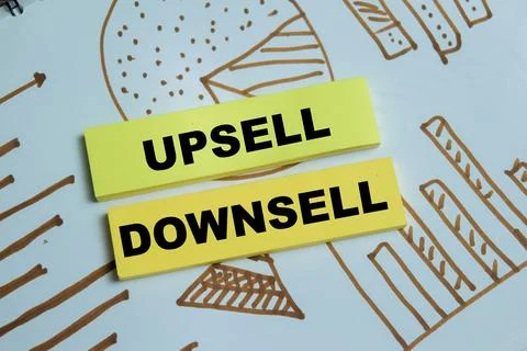 Concept of upsell or downsell write on sticky notes isolated on Wooden Table Stock Photos