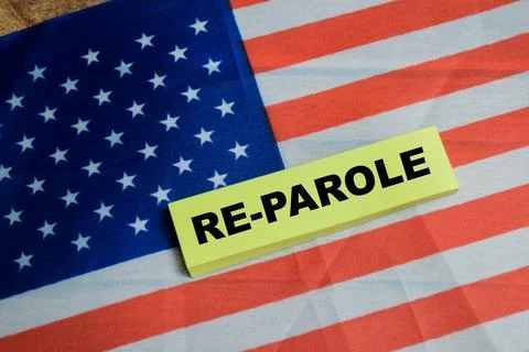 Concept of US Re-Parole write on sticky notes and the United States flag 스톡 사진