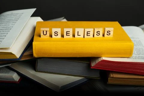 The concept of useless knowledge. Useless - word from wooden blocks Stock Photos