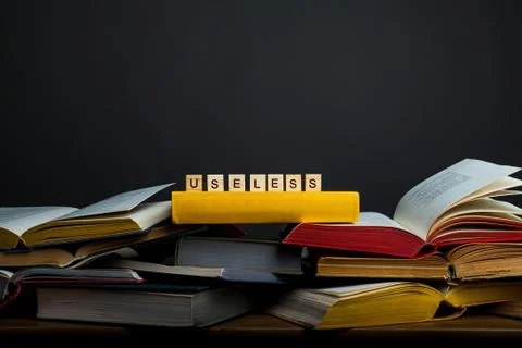 The concept of useless knowledge. Useless - word from wooden blocks Stock Photos