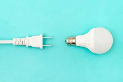 Concept of using electricity (light bulb and plug) Foto stock