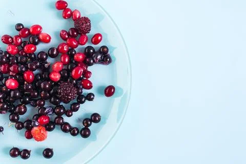 The concept of using quick-frozen products, a mixture of thawed berries. Stock Photos