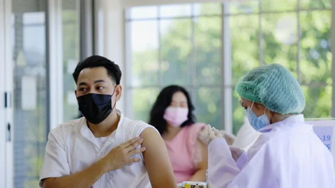 Concept Vaccination booster Covid 19. Doctors inject vaccines against new strain Stock-Footage 168512666