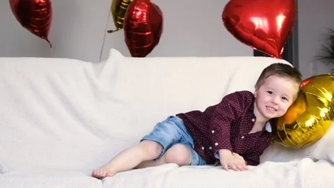 Concept for Valentine's Day. Fun party. A cute little Caucasian boy Stock Footage 146163409