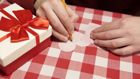 Concept of Valentine's Day. A man writes a romantic love message, text on a Stock Footage 170013348