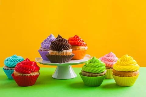 Concept of variety of choice, rainbow colour cupcakes Many vivid colours o... Stock Photos