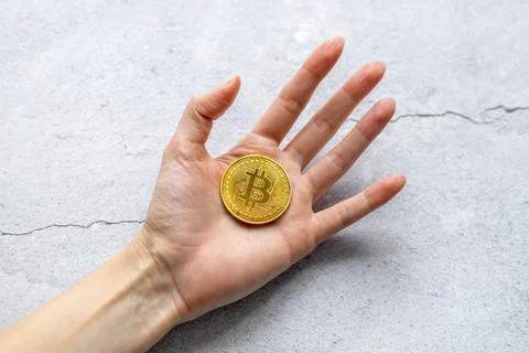 The concept of virtual cryptocurrency. Bitcoin money. A hand holding a gold.. Stock Photos