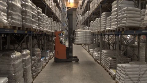Concept of warehouse. The forklift in the big warehouse on manufacturing plant Stock Footage 121010165