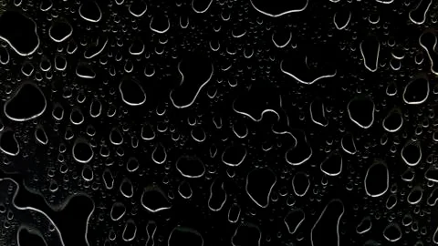 The concept of water drops on a black background. Stock Photos