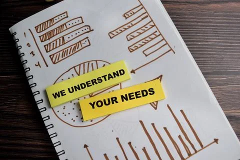 Concept of we understand your needs write on sticky notes isolated on Wooden Stock Photos