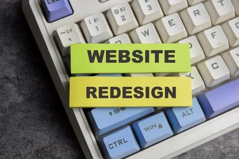 Concept of Website redesign write on sticky notes isolated on Wooden Table. Stock Photos