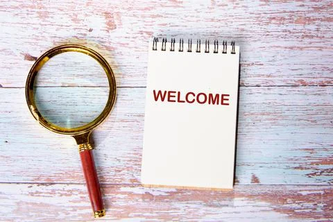 The concept of the welcome text write in a notebook on the boards next to the Stock Photos