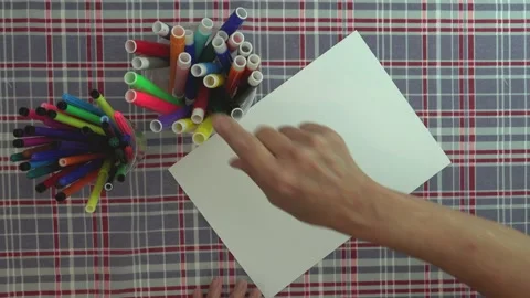 Concept. White paper on a table with checkered fabric, preparing to draw. Stock Footage 130571708