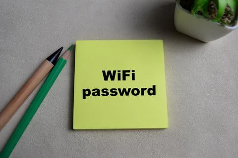 Concept of Wifi Password write on sticky notes isolated on Wooden Table. Stock Photos