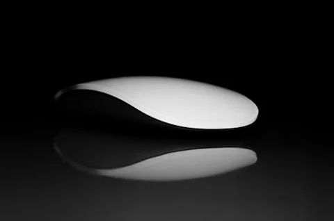 Concept with Wireless Computer Mouse and Reflection on Black Background Isola Stock Photos