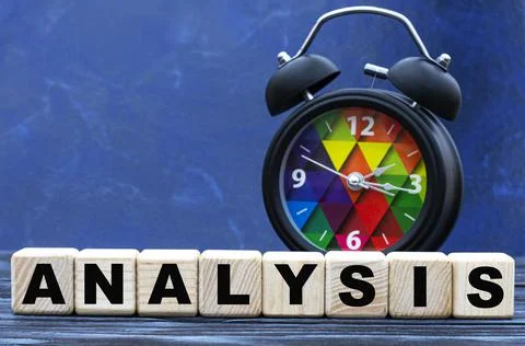 Concept word ANALYSIS on cubes on a dark blue background with an alarm clock Stock Photos