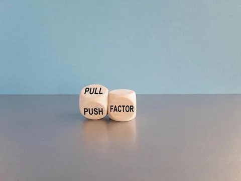 Concept word Pull factor and Push factor on wooden cubes. Stock Photos