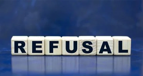 Concept word REFUSAL on cubes on a blue background Stock Photos