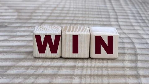 Concept of the word win on cubes on a beautiful background Stock Photos