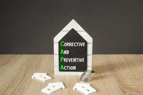 Concept words Corrective And Preventive Actions on black blackboard. Stock Photos