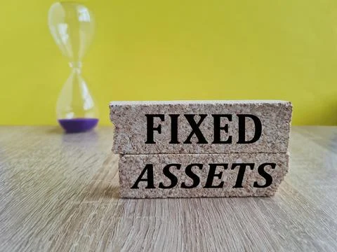Concept words fixed assets on beautiful brick blocks. Stock Photos
