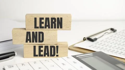 Concept words Learn and lead on wooden blocks. Beautiful white background Stock Photos