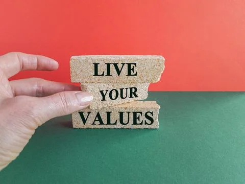 Concept words Live your values on brick blocks. Businessman hand. 写真素材