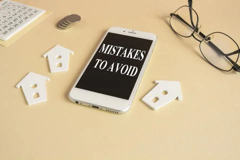 Concept words MISTAKES TO AVOID on the mobile phone screen. Stock Photos