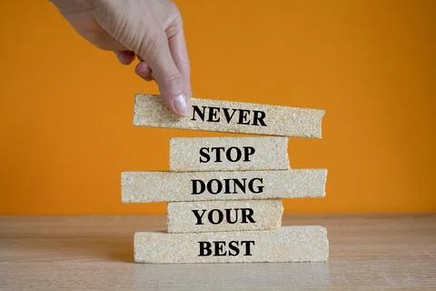 Concept words Never Stop Doing your Best on brick blocks. Stock Photos