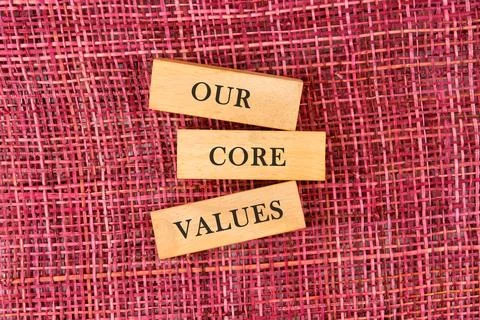 Concept words OUR CORE VALUES symbol on wooden blocks on a mesh background 스톡 사진