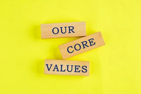 Concept words OUR CORE VALUES symbol on wooden blocks on a lemon background.  스톡 사진