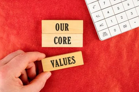 Concept words OUR CORE VALUES symbol. Wooden blocks. Beautiful red background 写真素材